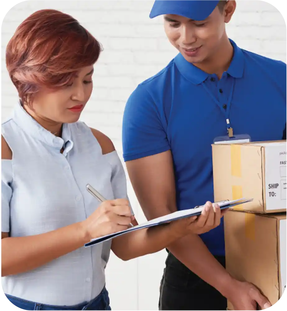 Customer receiving packaged electronics while signing a delivery confirmation document.